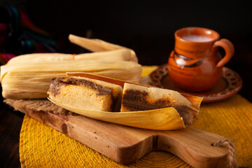 Tamales. hispanic dish typical of Mexico and some Latin American countries. Corn dough wrapped in corn leaves. The tamales are steamed.