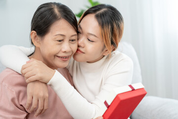 Mother day, cute asian teen girl hugging and kissing on the cheek, mature middle age mum. Love, kiss, care, happy smile enjoy family time. celebrate special occasion, happy birthday, merry Christmas.