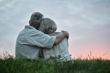 Portrait of happy elderly couple at sunset