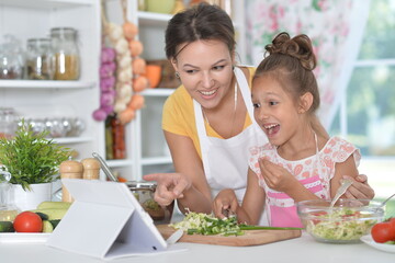 Portrait of mother and daughter cooking together