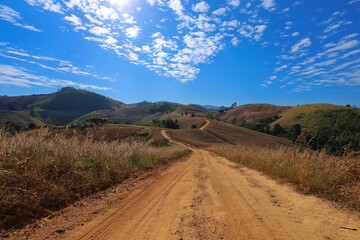 Dusty mountain road, beautiful sky,Dirt road in the mountains  northern Thailand
