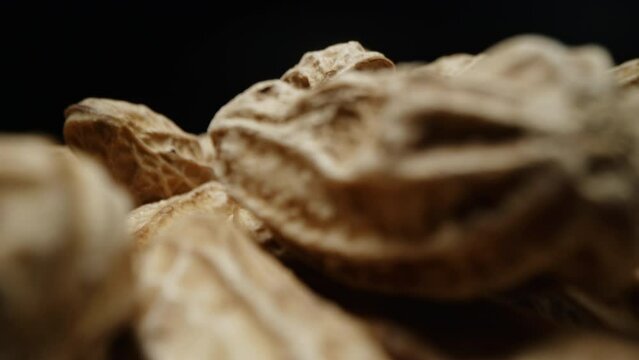 Macro closeup isolate footage of a lot raw peanut or groundnut with peel and unpeel for ingredient