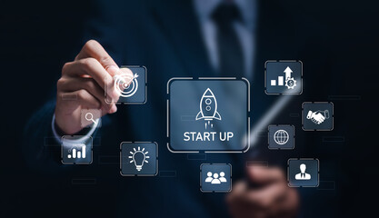 Startup business concept, strategic planning and business success. Businessman touching virtual rocket icon and startup.