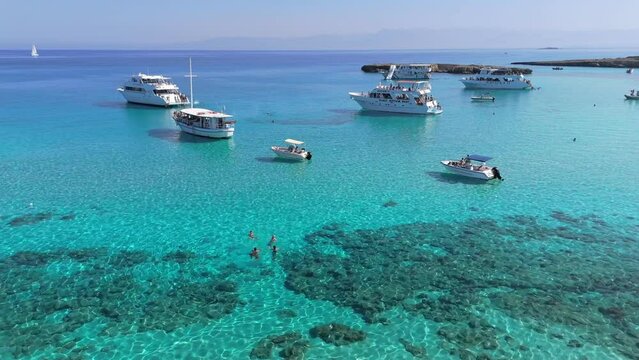 Aerial shot of famous blue lagoon on the island of Cyprus. Clear turquoise water of the Mediterranean Sea and yachts with tourists in the blue lagoon on the west coast of Cyprus