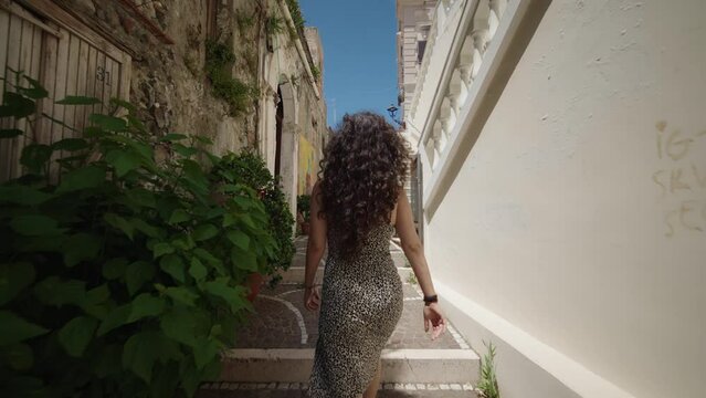 Woman walking exploring city of Diamante south Italy exploring 01