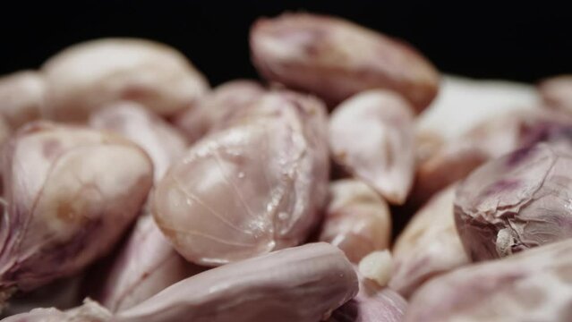 Macro closeup isolate footage of a lot raw peanut or groundnut with peel and unpeel for ingredient