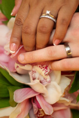 Obraz na płótnie Canvas Wedding Rings on Orchids