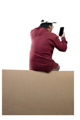 People in hat sit on the large packet for delivery while using mobile phones