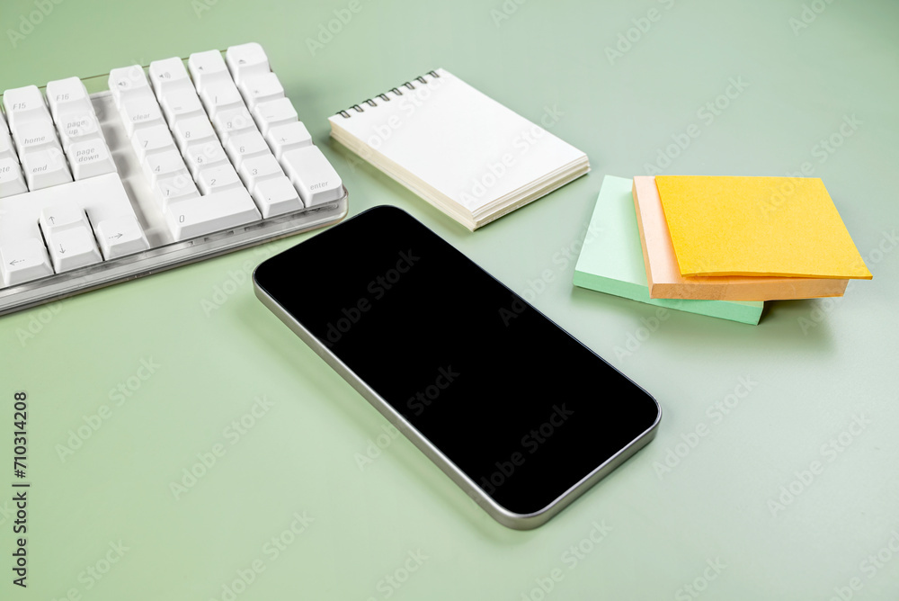 Aufkleber closeup view of mobile phone with blank screen and an empty notebook and note paper