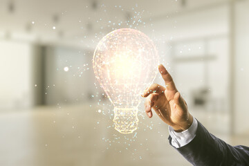 Male hand clicks on abstract virtual light bulb illustration on blurred office background, future...