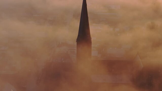 Aerial drone view of church foggy morning, Workum, Friesland, Netherlands