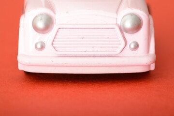 The close-up of a toy retro car highlights its miniature charm, offering a glimpse into the vintage...