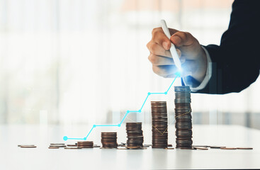 Coin stack with digital graphic indicator symbolizing business investment and economic growth....