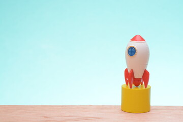 A toy rocket poised for launch embodies the anticipation and excitement of a new beginning,...
