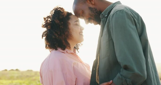 Couple, sunlight and forehead touch in nature for bonding together, love and happy in marriage. Interracial people, holiday and commitment in relationship, partnership and hug or loyal in outdoors