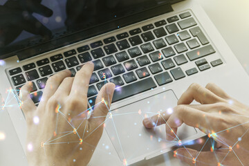 Creative concept of wireless technology and hands typing on laptop on background. Big data and...