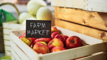 Selection of Tasty Red Apples with a Farm Market Sign on a Food Stall with Fresh Organic Fruits and...