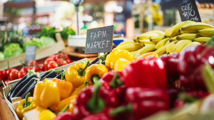 Farmers Market Food Stall with a Selection of Ecological Fruits and Vegetables. Organic Red and Yellow Bell Peppers, Eggplants, Natural Chemical-Free Bananas and Other Groceries on the Outdoors Stand