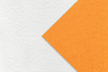 Texture of white paper background, half two colors with orange arrow, macro. Structure of dense...