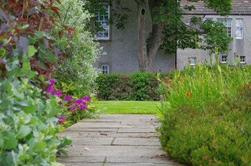 Romantic backstreets with English landscape gardens in bloom in historic old town of Kirkwall, Scotland, a landmark sightseeing tourist spot in downtown Orkney Islands