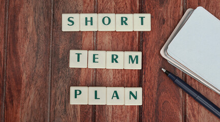 Short term plan written with scrabbles on a wooden background