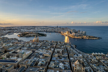 Aerial beautiful drone view of sunset in Valletta old harbour, Malta