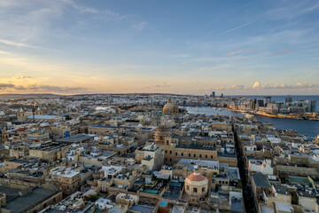Fototapeta premium Aerial beautiful drone view of sunset in Valletta old harbour, Malta
