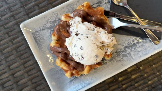 Chocolate waffle with scoop of stracciatella and chocolate ice cream