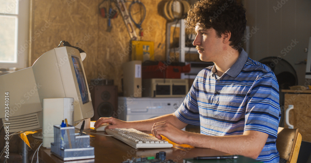 Leinwandbilder Caucasian Male Software Engineer Programming On Old Desktop Computer In Retro Garage. Enthusiast Browsing Early Internet Forums, Coding Applications In Nineties. Nostalgia Concept
