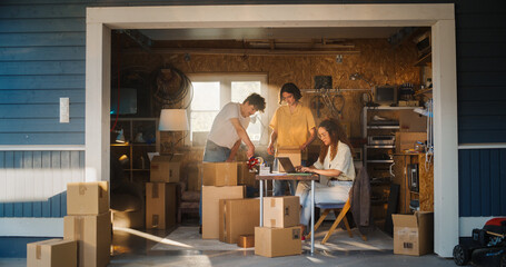 Diverse Small Business Partners Working in Home Garage. Hispanic Female Manager Filling Online...