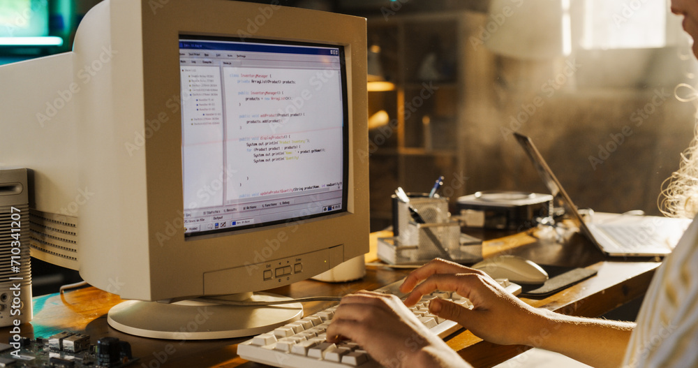 Poster Side View Of Hispanic Female Engineering Student Writing Academic Thesis On Old Desktop Computer In Retro Garage. Future Engineer Focused On Innovative Project For University Of Technology In Nineties