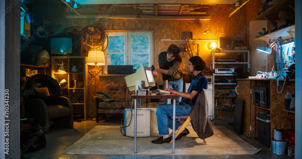 Poster Two Caucasian Male Tech Startup Founders Using Old Desktop Computer In Retro Garage In The Evening. Software Developer And User Experience Designer Starting New E-commerce Business In Nineties.