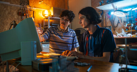 Portrait Of Caucasian Male Tech Startup Founders Using Old Desktop Computer In Retro Garage In The...