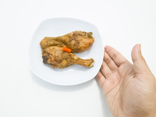 Spicy sweet and sour fried chicken in a white plate on a white background