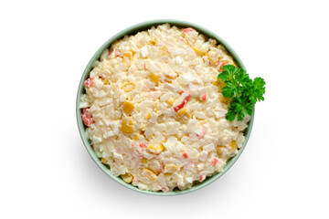 Crab stick salad in a plate on a white background. Crab stick salad with parsley. Top view.