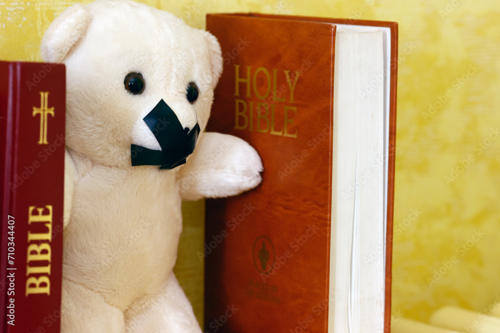 Wall mural bibles and teddy bear with tape on his mouth. symbol of silence on child abuse and victim in christi - Wall murals