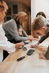 Three generations cut out sugar cookies, kitchen delight