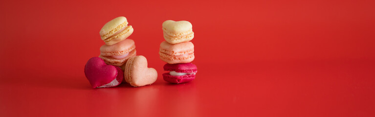 flat lay heart shape of macarons on red background