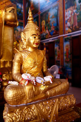 Mongkol Serei Kien Khleang Pagoda. Golden buddha statue with jasmine flowers.  Phnom Penh; Cambodia.