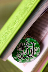 The Quran, holy book of Muslims from God with Allah monogram. Symbols of islam.