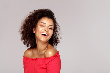 Happy smiling african woman with afro hairstyle looking at camera.