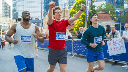 Happy Young Male Celebrating, Raising Hands While Crossing the Finish Line in a Race. Portrait of a...
