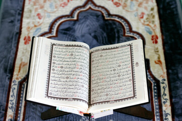 Mubarak mosque. Open Quran in arabic on wood stand. Symbol of Islam. Vietnam.