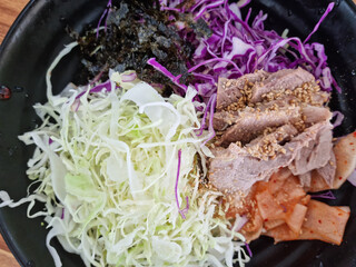 Vegetables and meat toppings on the bibim noodles.