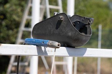 Welding Machine Handle and Mask on a Construction Site - 710366088