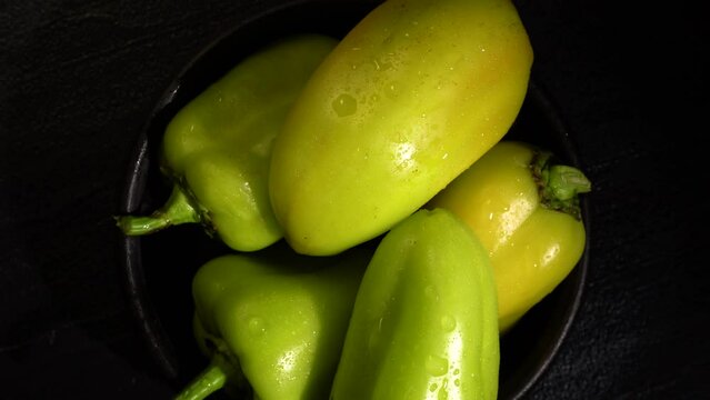 Ripe Sweet Bell Peppers Are Covered With Drops Of Water In A Bowl On A Black Background. View From Above. Close-up. Black Background. 