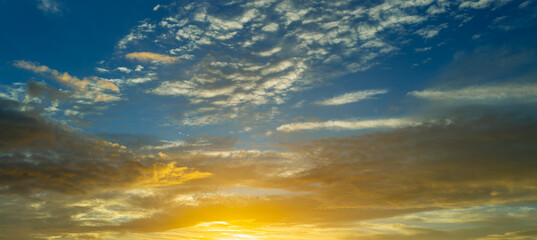 Sunset or sunrise. Dramatic majestic scenery sunset. Sky with clouds in sunset sky light...