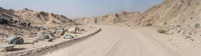 bending gravel road and basalt boulders at Moonlandscape, near Swakopmund, Namibia