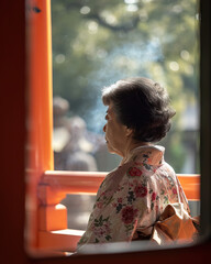Elderly woman in traditional kimono at a Kyoto shrine, capturing the serene essence of Japanese culture and heritage in the peaceful morning light