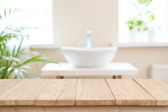 Blurred bathroom sink background and counter table top of wooden planks for products display montage